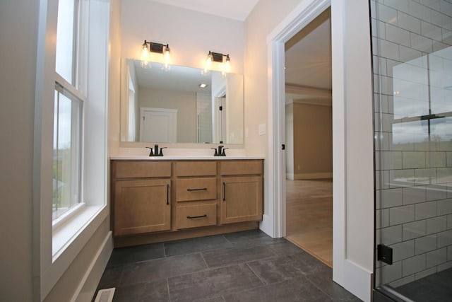 bathroom with visible vents, a stall shower, a sink, and double vanity