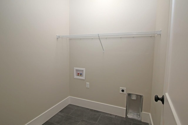 clothes washing area featuring hookup for a washing machine, baseboards, laundry area, electric dryer hookup, and dark tile patterned floors