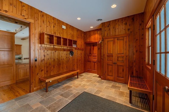 mudroom featuring wooden walls, visible vents, a sauna, recessed lighting, and stone finish flooring