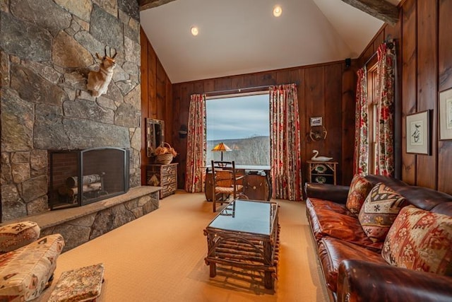 carpeted living room with wood walls, a fireplace, and vaulted ceiling with beams