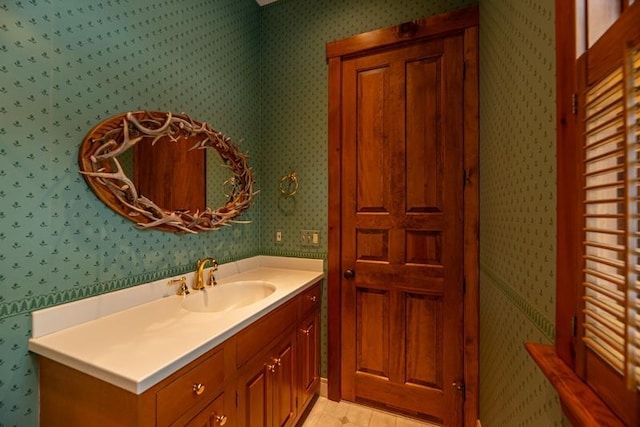 bathroom featuring wallpapered walls and vanity