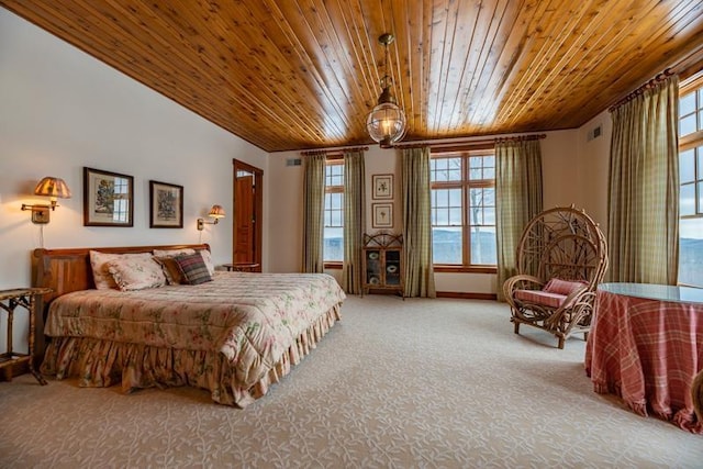 carpeted bedroom with wooden ceiling