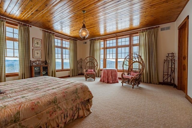 bedroom featuring wooden ceiling, multiple windows, visible vents, and carpet floors