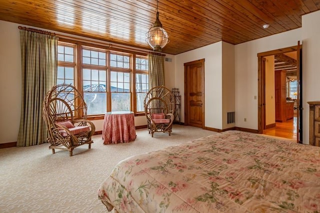 bedroom featuring wooden ceiling, carpet, and baseboards