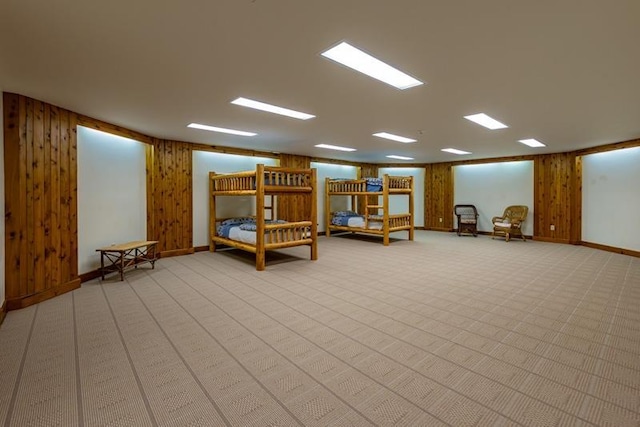 interior space featuring carpet and wood walls