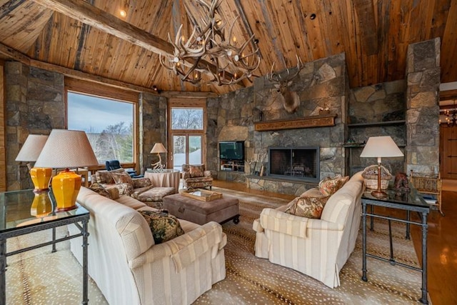 living area featuring beamed ceiling, a stone fireplace, wooden ceiling, an inviting chandelier, and high vaulted ceiling