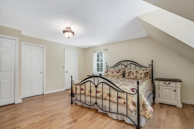 bedroom with baseboards and wood finished floors