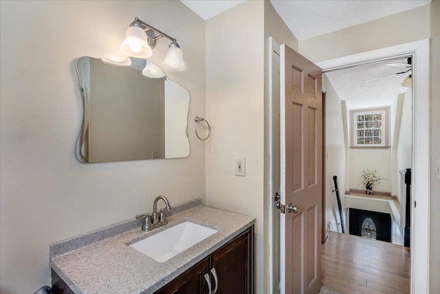 bathroom featuring a textured ceiling and vanity