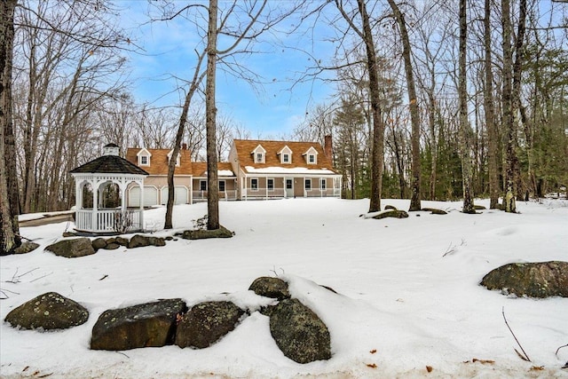 snowy yard with a gazebo and a garage