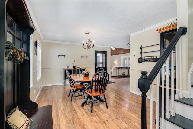 dining room with light wood-style flooring, stairway, crown molding, baseboards, and a chandelier