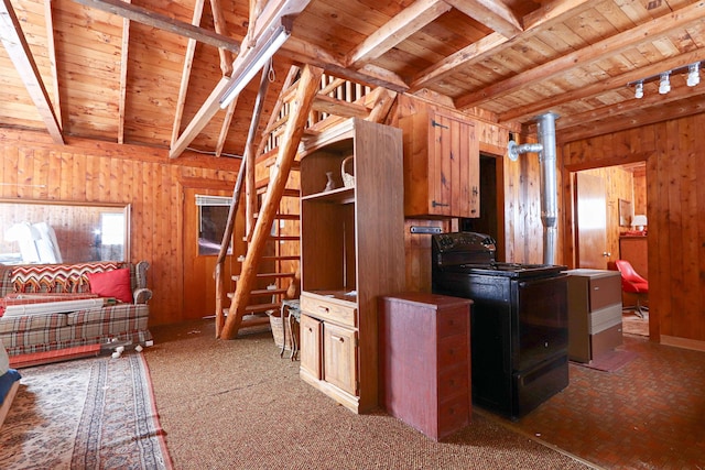 kitchen featuring wooden walls, wood ceiling, beam ceiling, black electric range, and washer / clothes dryer