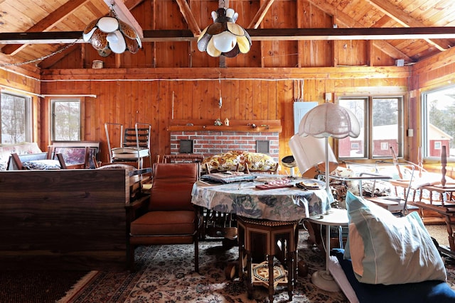 interior space featuring a wealth of natural light, wood ceiling, wood walls, and lofted ceiling with beams