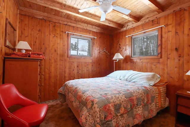 bedroom with wood walls, wood ceiling, beam ceiling, carpet flooring, and a ceiling fan