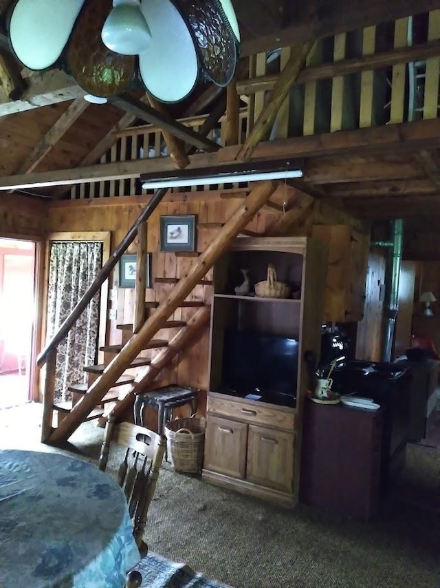 living area featuring stairs and vaulted ceiling