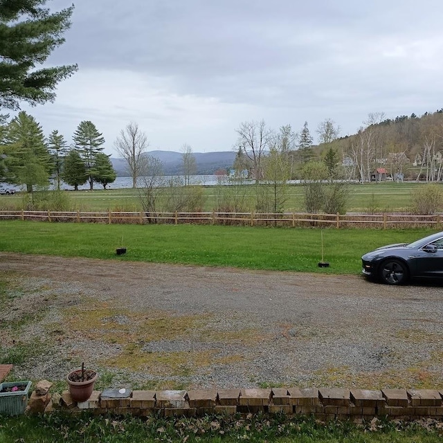 view of yard with a rural view and fence