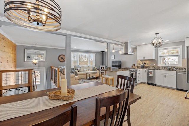 dining space with recessed lighting, a notable chandelier, crown molding, and light tile patterned floors