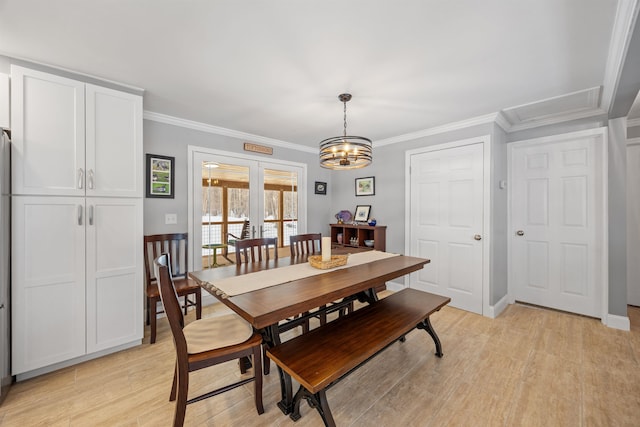 dining area featuring light wood finished floors, french doors, and ornamental molding