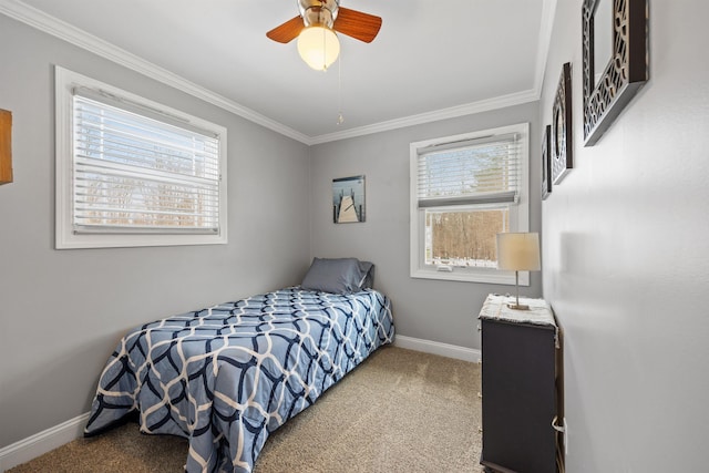 carpeted bedroom with crown molding, a ceiling fan, and baseboards