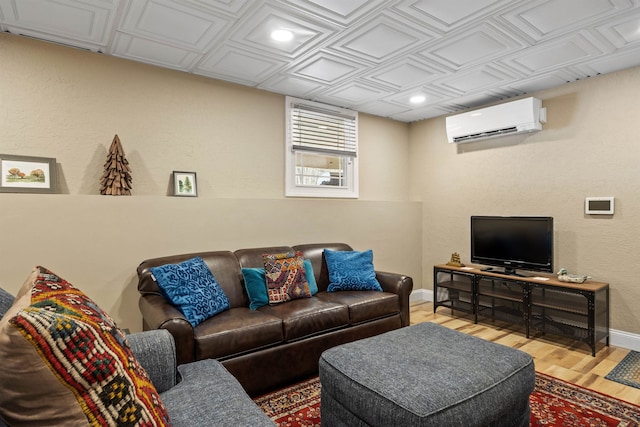 living room featuring wood finished floors, baseboards, a wall mounted AC, recessed lighting, and an ornate ceiling