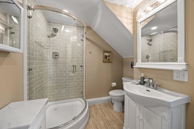 full bath featuring toilet, lofted ceiling, a shower stall, baseboards, and vanity