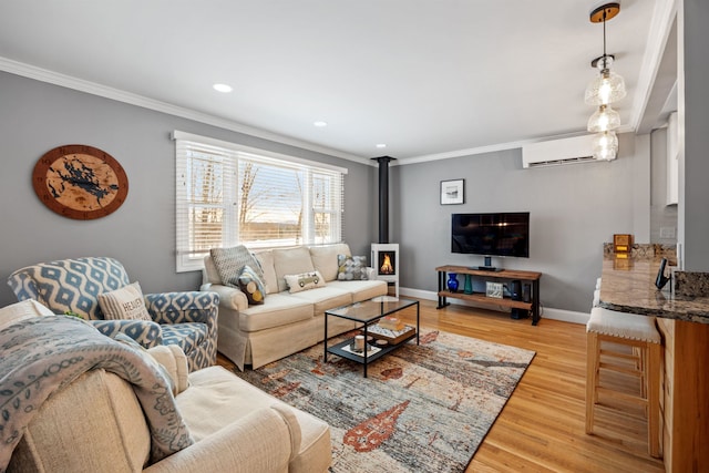 living area with a wood stove, baseboards, light wood finished floors, and ornamental molding