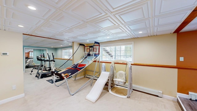 exercise area featuring plenty of natural light, recessed lighting, and a baseboard radiator