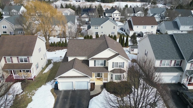 snowy aerial view with a residential view