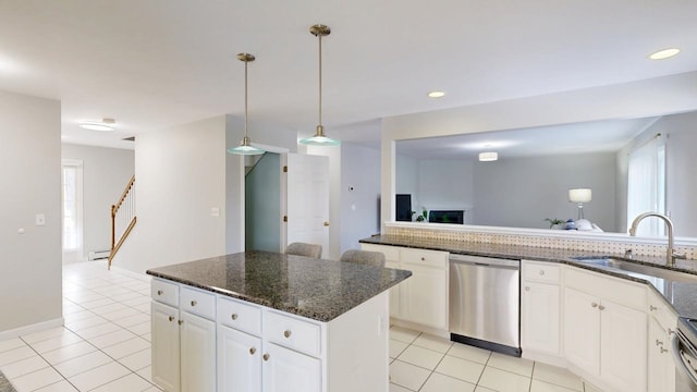 kitchen featuring a sink, light tile patterned flooring, a wealth of natural light, and stainless steel appliances