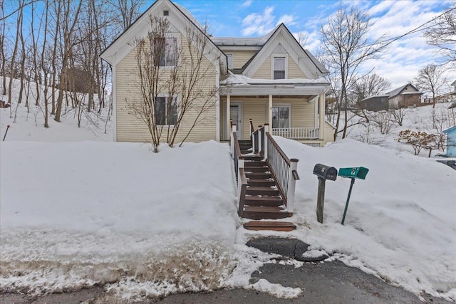 view of front of house with stairway and covered porch