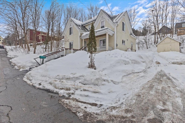 snow covered property featuring a garage