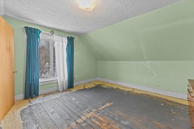 bonus room with baseboards, a textured ceiling, and lofted ceiling