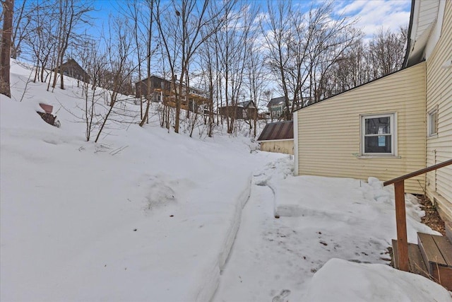 yard covered in snow featuring a garage