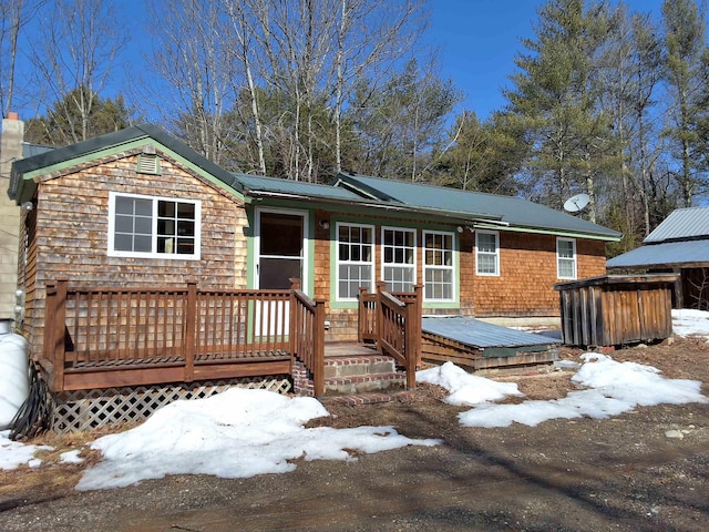 view of front of property with a chimney and a deck