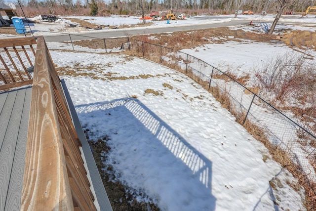 yard covered in snow with fence