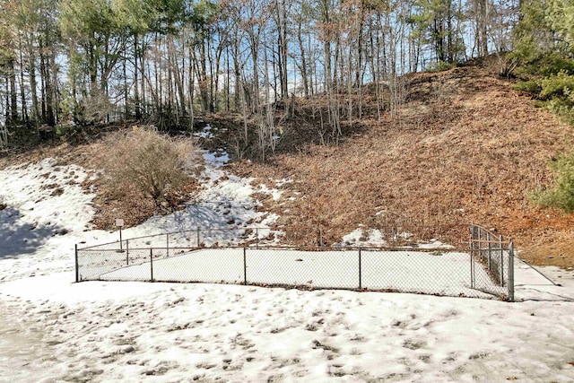 yard layered in snow with fence