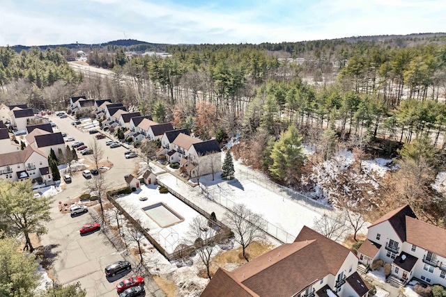 drone / aerial view featuring a forest view and a residential view