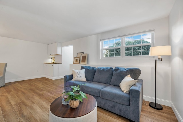 living room with light wood-style flooring and baseboards