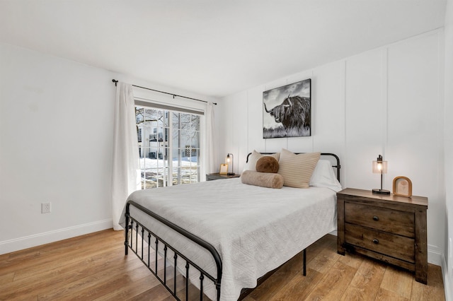 bedroom featuring light wood-style flooring and baseboards