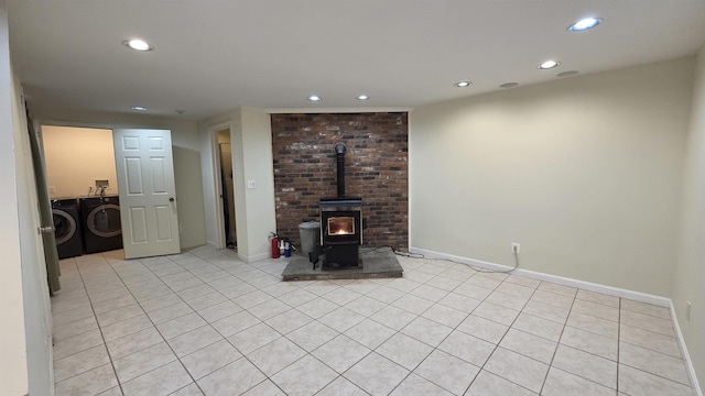 living area with recessed lighting, baseboards, separate washer and dryer, and a wood stove