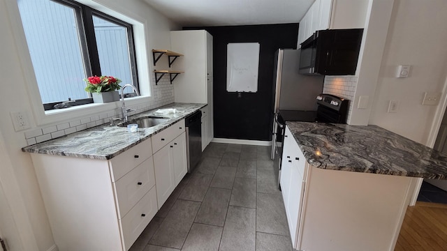 kitchen with a sink, open shelves, black microwave, stainless steel electric range oven, and dishwasher