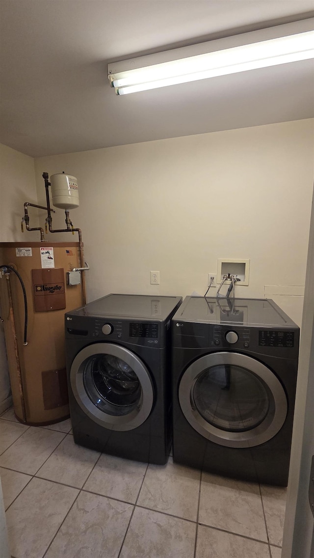 clothes washing area with laundry area, separate washer and dryer, and water heater