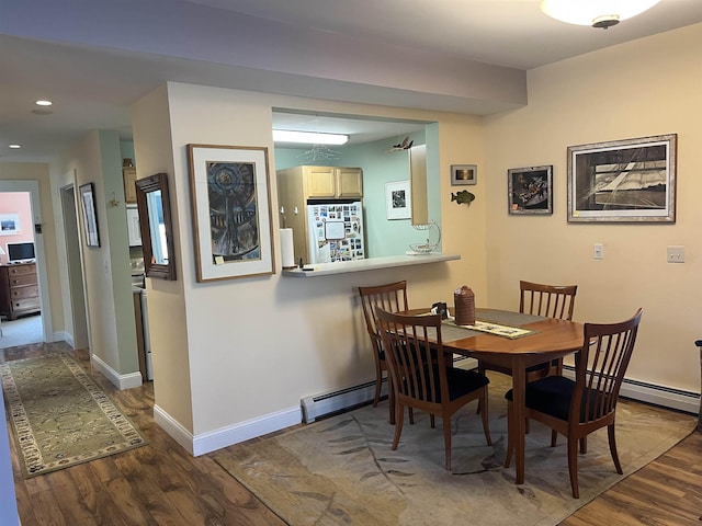 dining room featuring recessed lighting, a baseboard radiator, baseboards, and wood finished floors