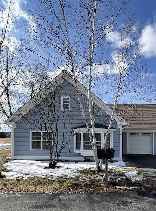 view of front of house featuring a garage and aphalt driveway