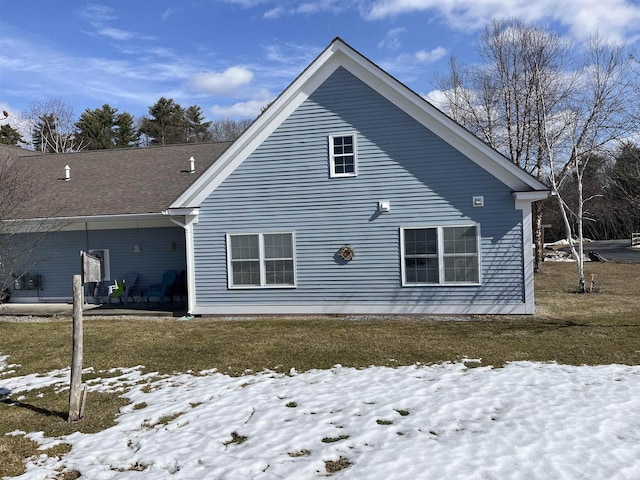 view of snowy exterior with a yard