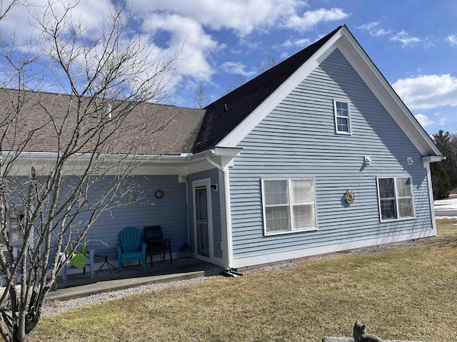 rear view of house featuring a yard and a patio