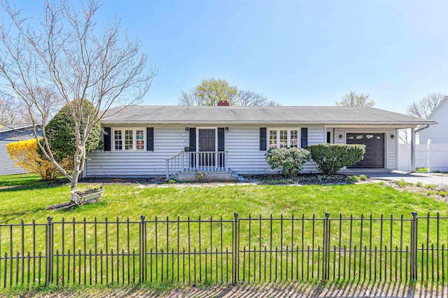 ranch-style home featuring a front lawn, an attached garage, fence, and driveway