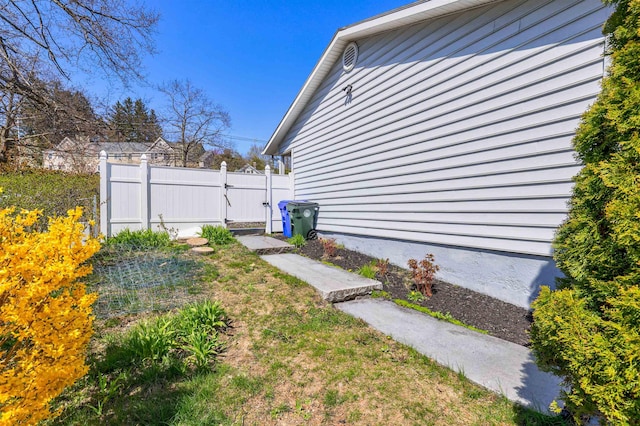 view of home's exterior with a gate and fence