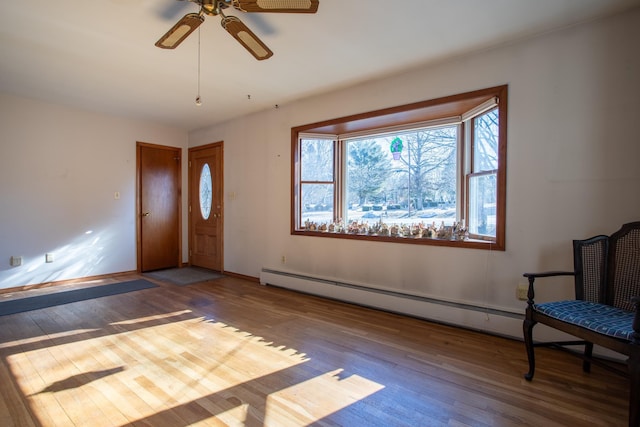 foyer featuring ceiling fan, baseboards, and hardwood / wood-style floors