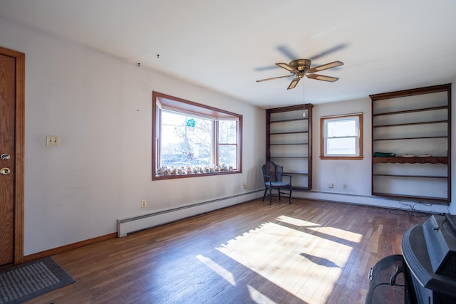 spare room featuring a ceiling fan, wood finished floors, and baseboards