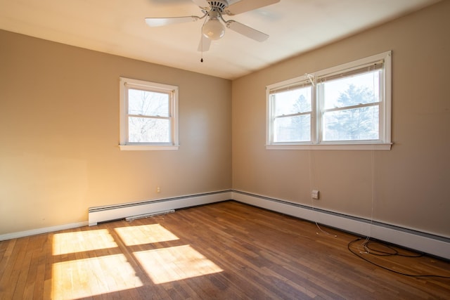 empty room with a baseboard heating unit, a ceiling fan, baseboards, and wood-type flooring